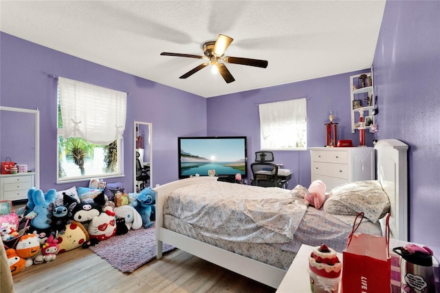 bedroom featuring hardwood / wood-style flooring and ceiling fan