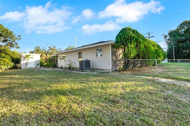 exterior space featuring a yard and central AC