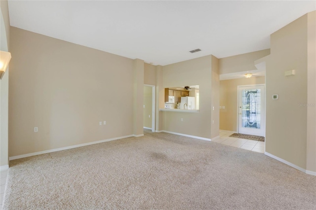 carpeted spare room with ceiling fan