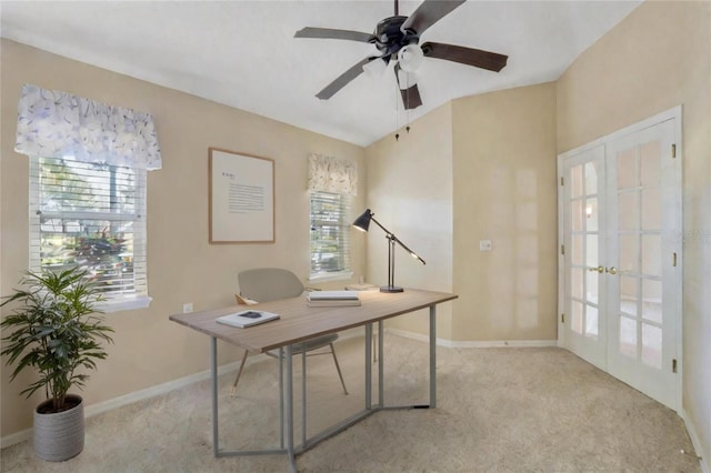 carpeted office space featuring french doors and ceiling fan