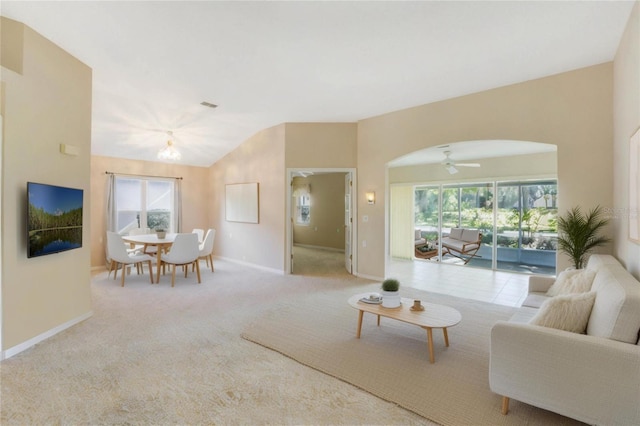 living room with a wealth of natural light, ceiling fan, and light carpet