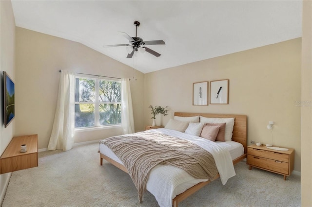 bedroom featuring ceiling fan, light colored carpet, and vaulted ceiling