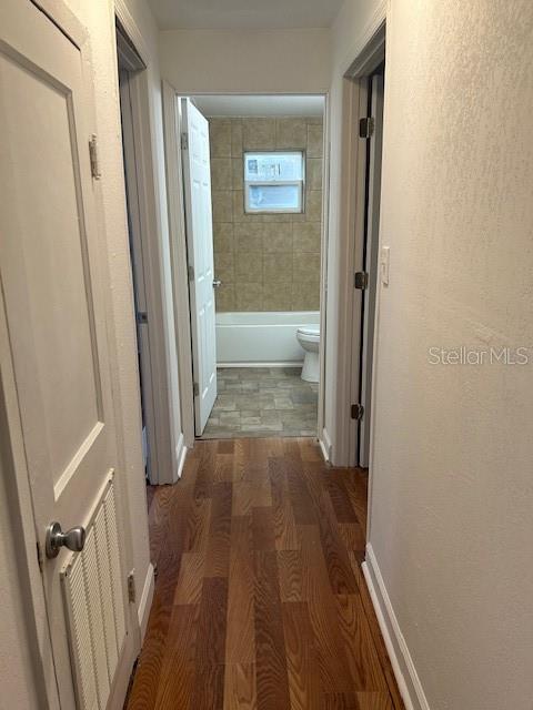 hall with dark hardwood / wood-style floors