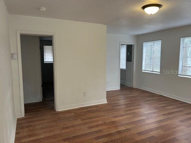 empty room featuring dark hardwood / wood-style flooring