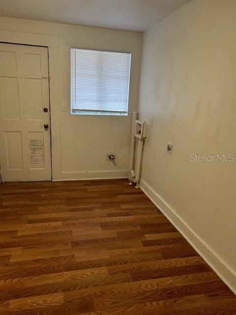 laundry room with dark wood-type flooring