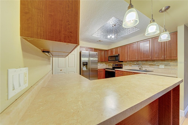 kitchen featuring pendant lighting, decorative backsplash, sink, and stainless steel appliances