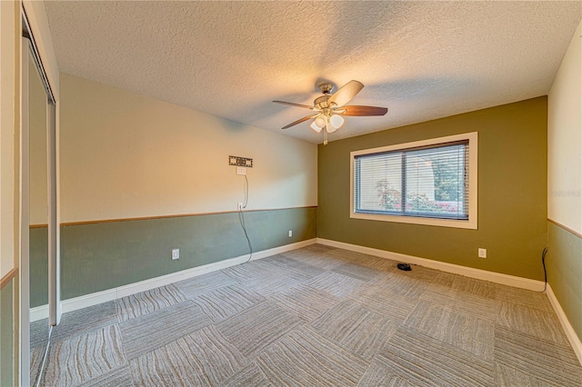 unfurnished room featuring a textured ceiling and ceiling fan