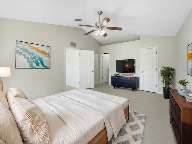 bedroom with light tile patterned floors, vaulted ceiling, and ceiling fan