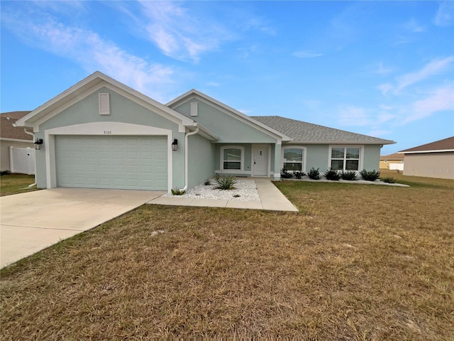 ranch-style house with a garage and a front lawn