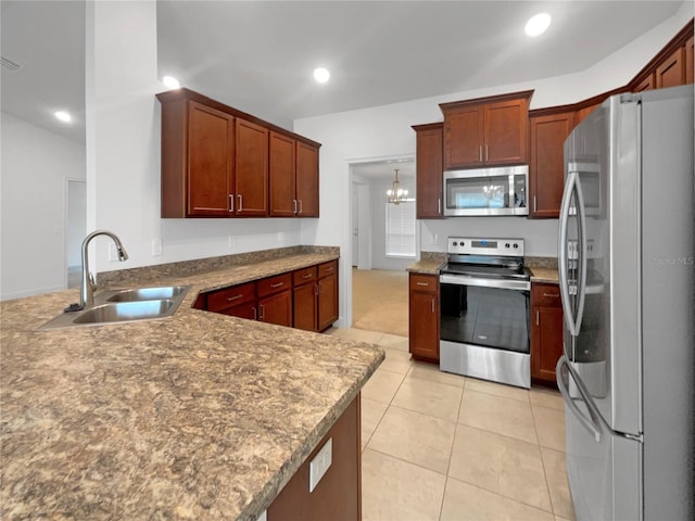 kitchen with hanging light fixtures, sink, light tile patterned floors, appliances with stainless steel finishes, and a chandelier