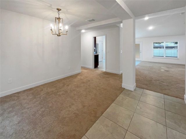 carpeted empty room featuring an inviting chandelier