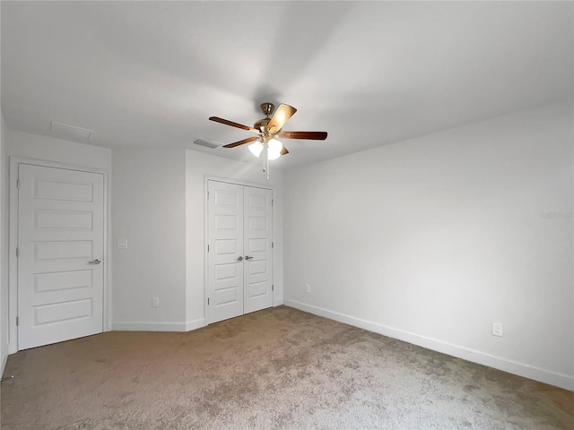 unfurnished bedroom featuring ceiling fan, carpet floors, and a closet