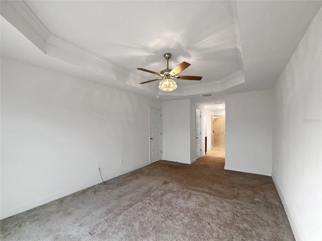 carpeted empty room featuring a tray ceiling, ceiling fan, and crown molding