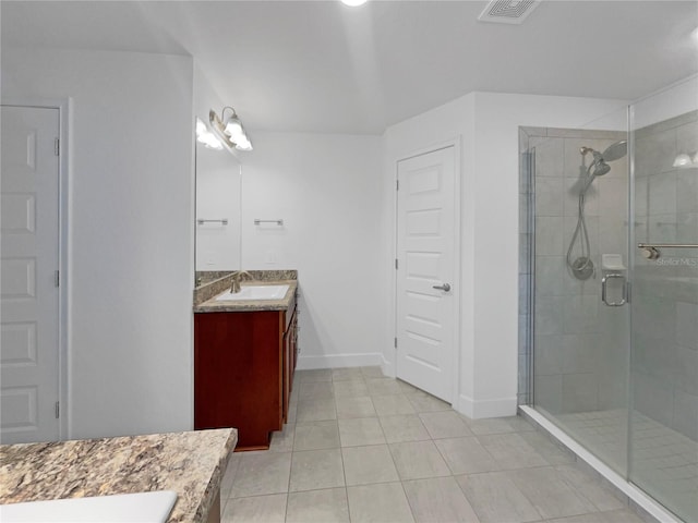 bathroom featuring vanity, tile patterned floors, and a shower with door