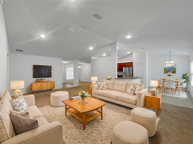 tiled living room with vaulted ceiling and a notable chandelier