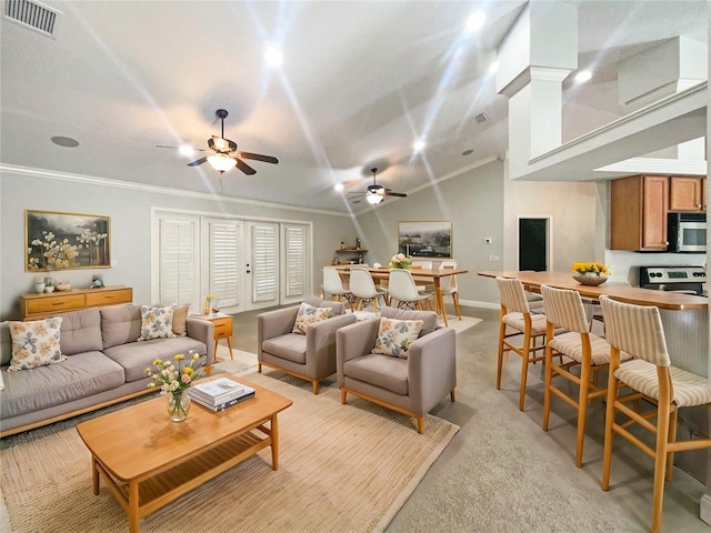 carpeted living room featuring vaulted ceiling, ceiling fan, and ornamental molding