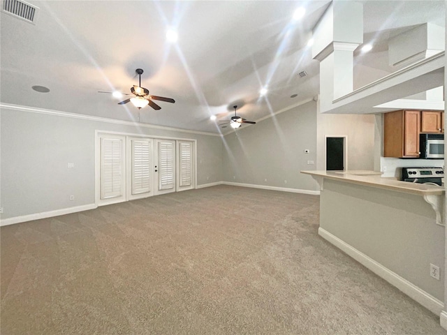 unfurnished living room featuring carpet, ceiling fan, and crown molding