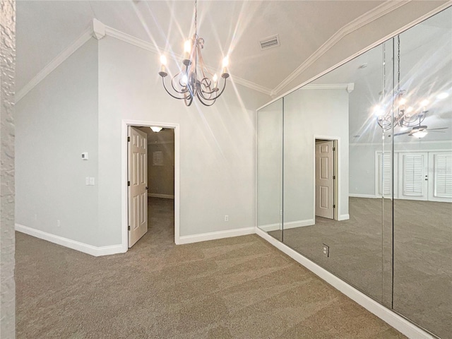 interior space featuring lofted ceiling, ceiling fan with notable chandelier, and crown molding