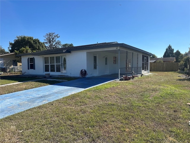 view of front of property with a front lawn and a carport