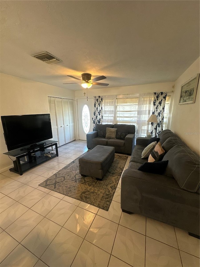 living room with light tile patterned floors and ceiling fan