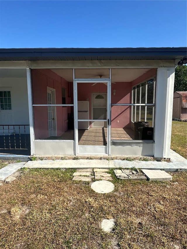 rear view of house featuring a sunroom