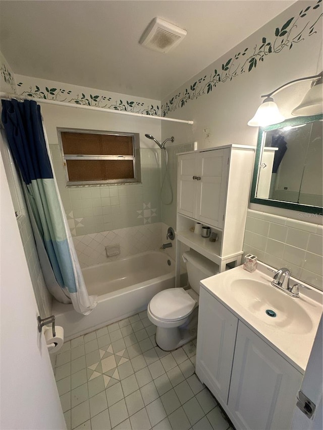 full bathroom featuring shower / tub combo, tile patterned floors, backsplash, toilet, and vanity