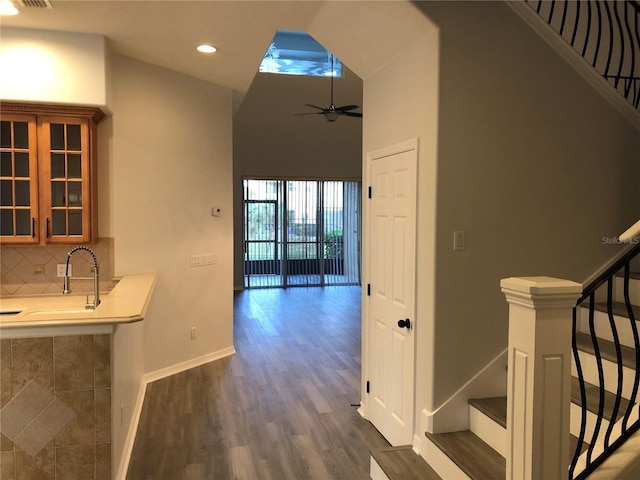 corridor with dark hardwood / wood-style flooring and sink