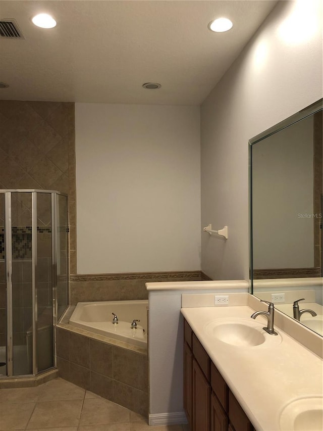 bathroom with tile patterned floors, vanity, and separate shower and tub