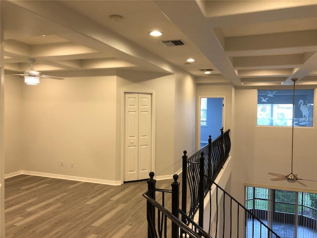 interior space with plenty of natural light, beamed ceiling, coffered ceiling, and hardwood / wood-style flooring