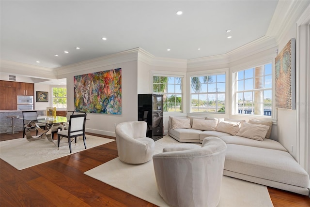 living room featuring visible vents, light wood finished floors, and ornamental molding