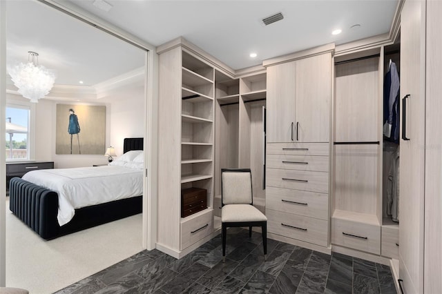 walk in closet with visible vents, a notable chandelier, and marble finish floor