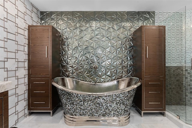 bathroom featuring tile patterned floors and a freestanding bath