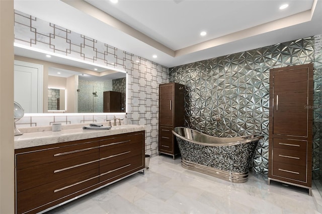 full bath featuring vanity, recessed lighting, wallpapered walls, and a freestanding bath