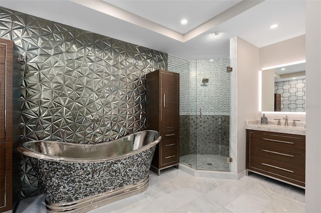 full bath with a freestanding tub, marble finish floor, a stall shower, and vanity