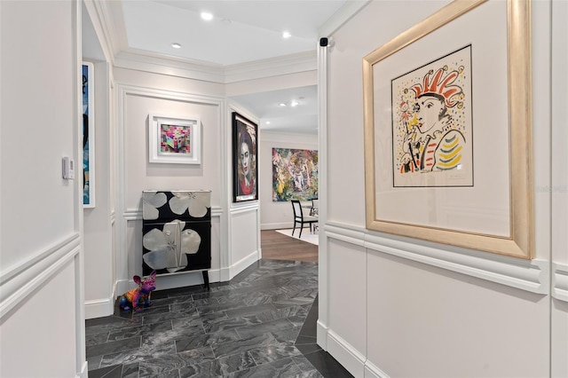 hallway featuring recessed lighting, crown molding, and a decorative wall