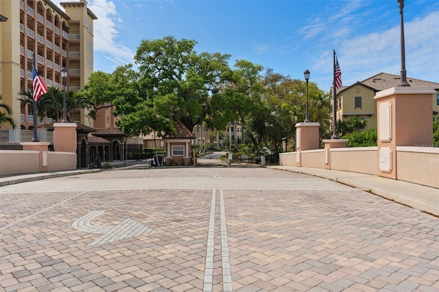 view of street featuring curbs, street lighting, and sidewalks