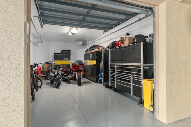 garage with a garage door opener and a textured wall