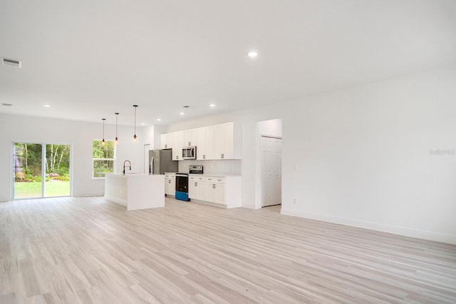 unfurnished living room with light hardwood / wood-style floors and sink