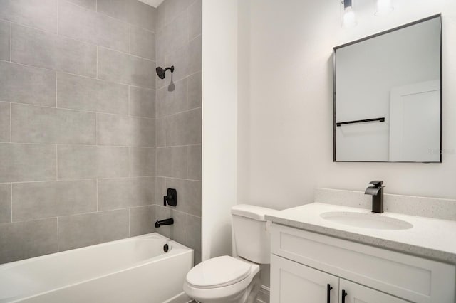 full bathroom with vanity, tiled shower / bath combo, and toilet