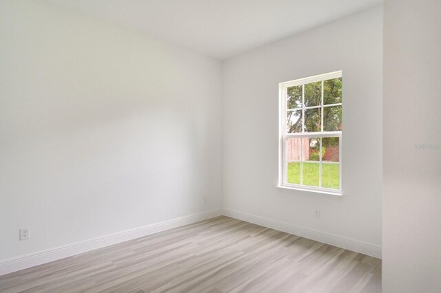 spare room featuring light hardwood / wood-style floors