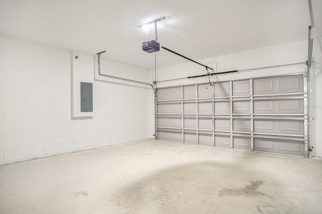 garage with electric panel and a garage door opener