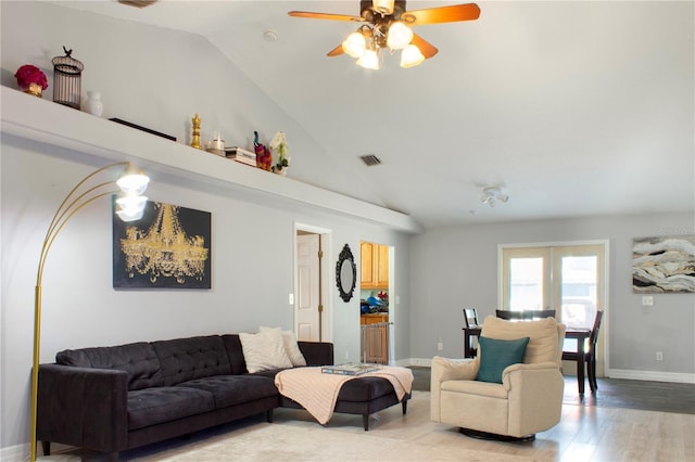 living room with hardwood / wood-style floors, ceiling fan, and high vaulted ceiling