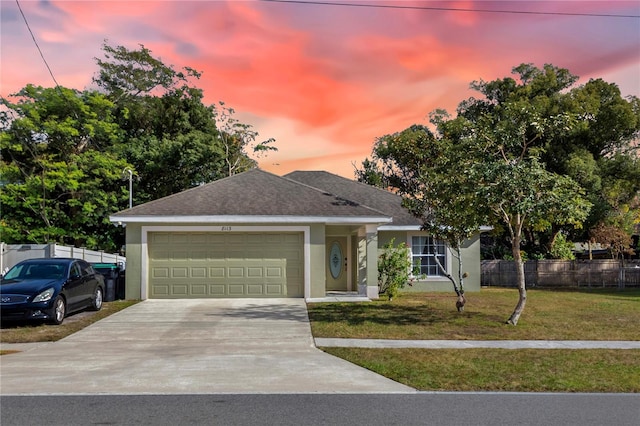 view of front facade featuring a yard and a garage