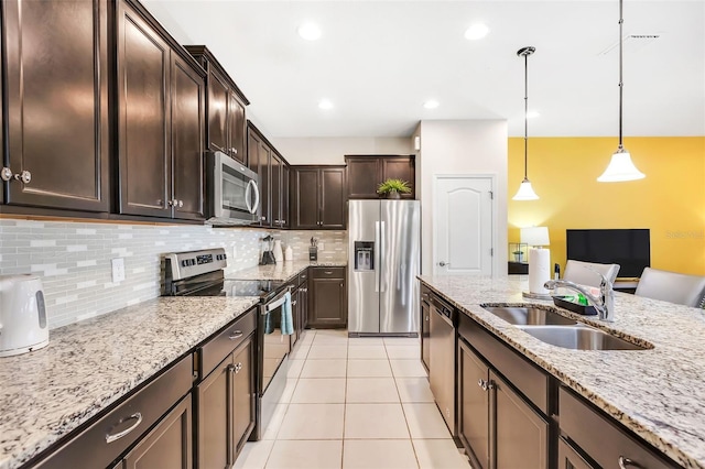 kitchen featuring dark brown cabinets, hanging light fixtures, sink, and appliances with stainless steel finishes