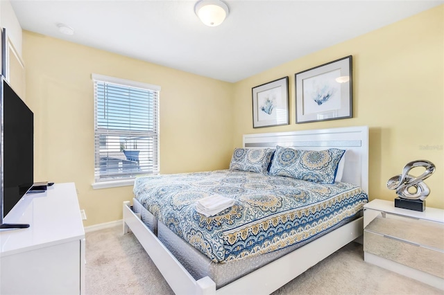 bedroom featuring light carpet