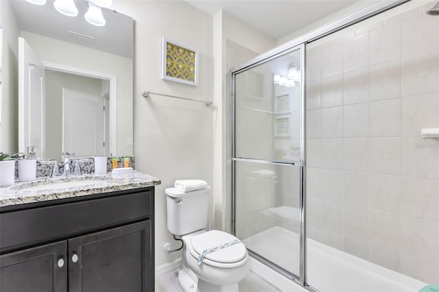 bathroom with vanity, toilet, and an enclosed shower