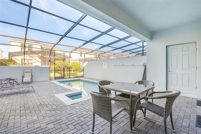 view of swimming pool with glass enclosure and a patio area