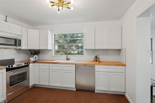 kitchen featuring appliances with stainless steel finishes, sink, and white cabinets