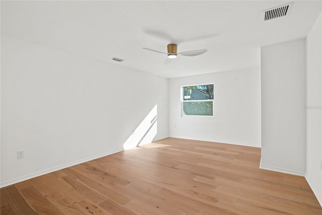 empty room with ceiling fan and light hardwood / wood-style floors