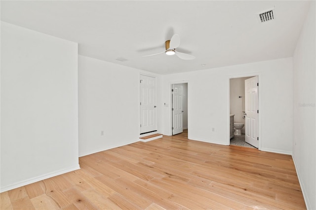 spare room with ceiling fan and light wood-type flooring